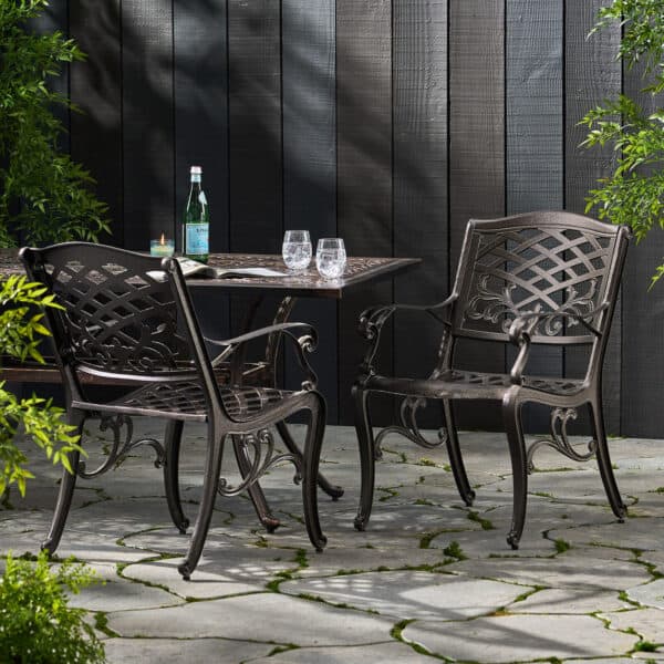 A patio set with a table and chairs on a stone patio.
