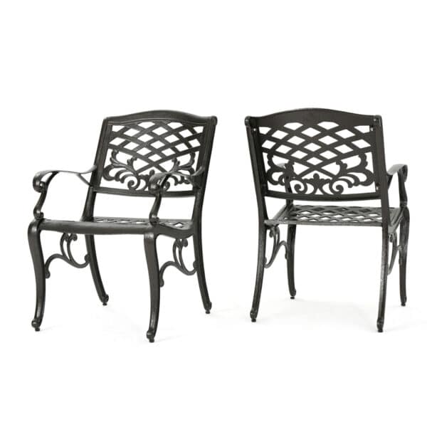 A pair of black wrought iron chairs on a white background.