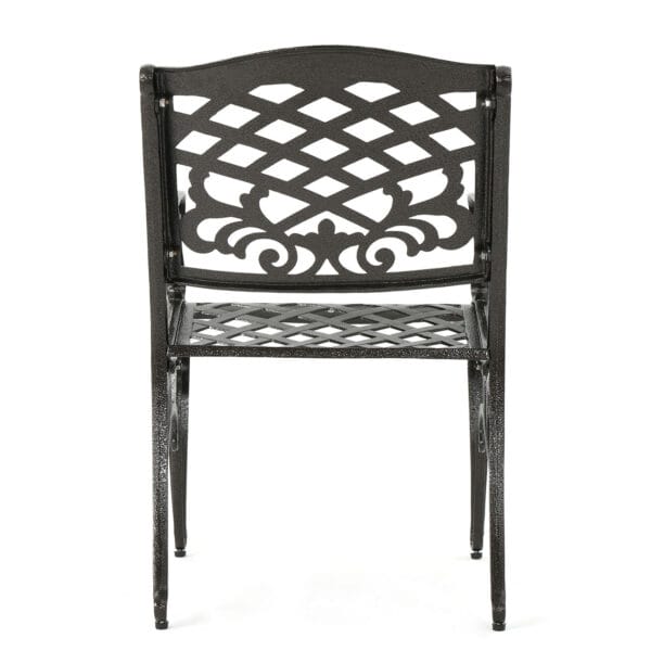 A black metal dining chair with an ornate design.