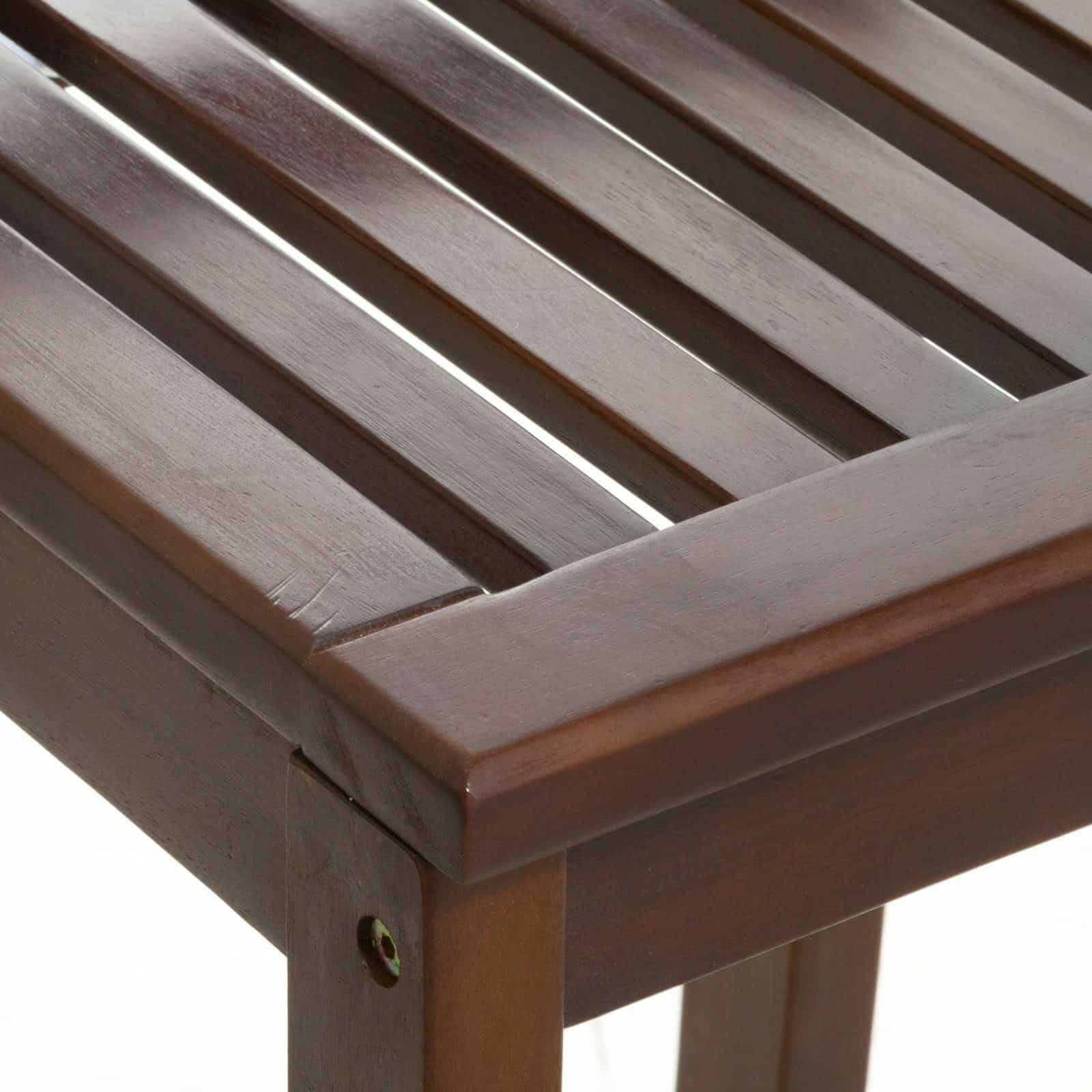 A close up of a wooden bench with slats.