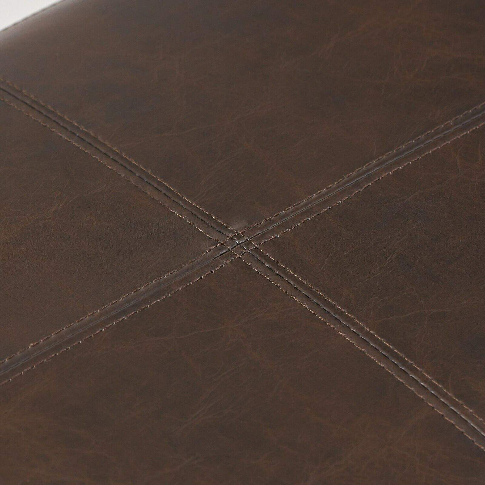 A close up view of a brown leather ottoman.
