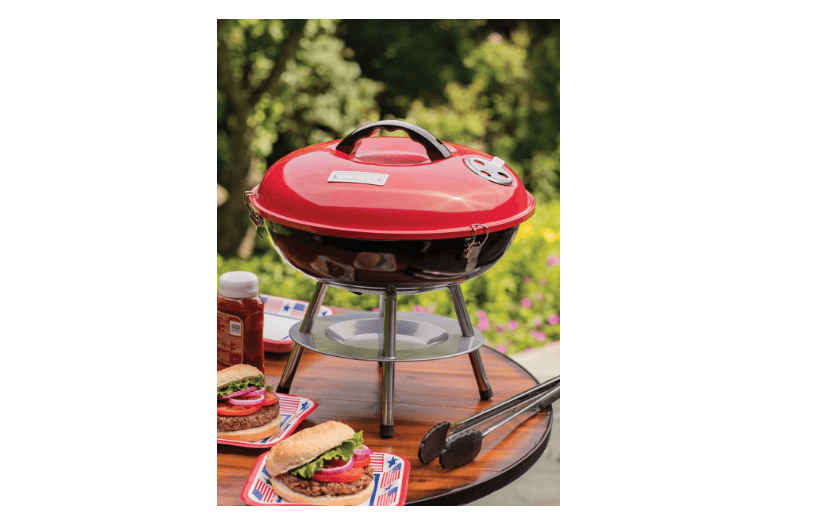 A bbq grill on a table with burgers on it.