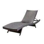 A black wicker chaise lounge on a white background.