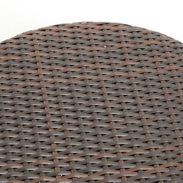 A close up of a round wicker table.