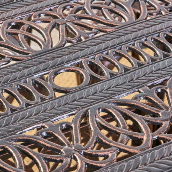 A close up of an ornate wrought iron bench.