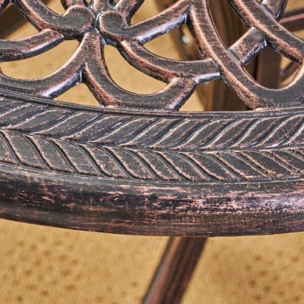 A close up view of a cast iron patio chair.