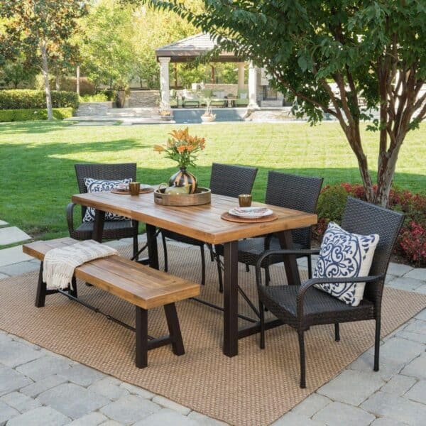 A patio set with a wooden table and chairs.