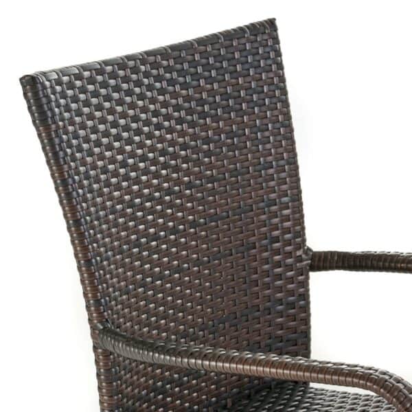 A brown wicker dining chair on a white background.