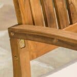 A close up of a wooden chair with a cushion.