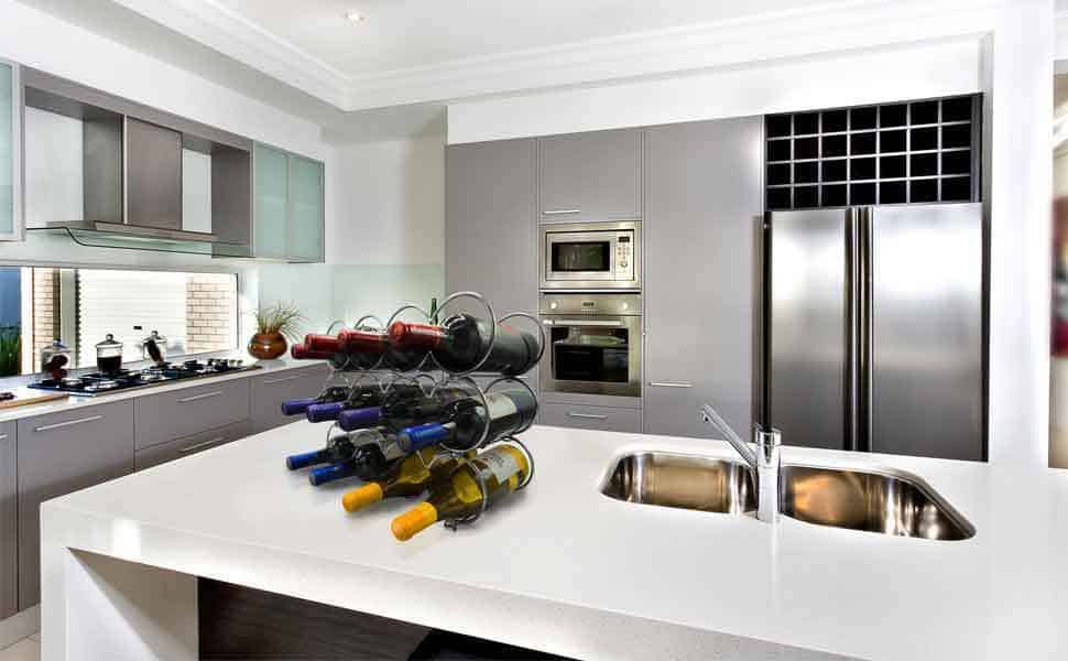 A modern kitchen with stainless steel appliances and a wine rack.