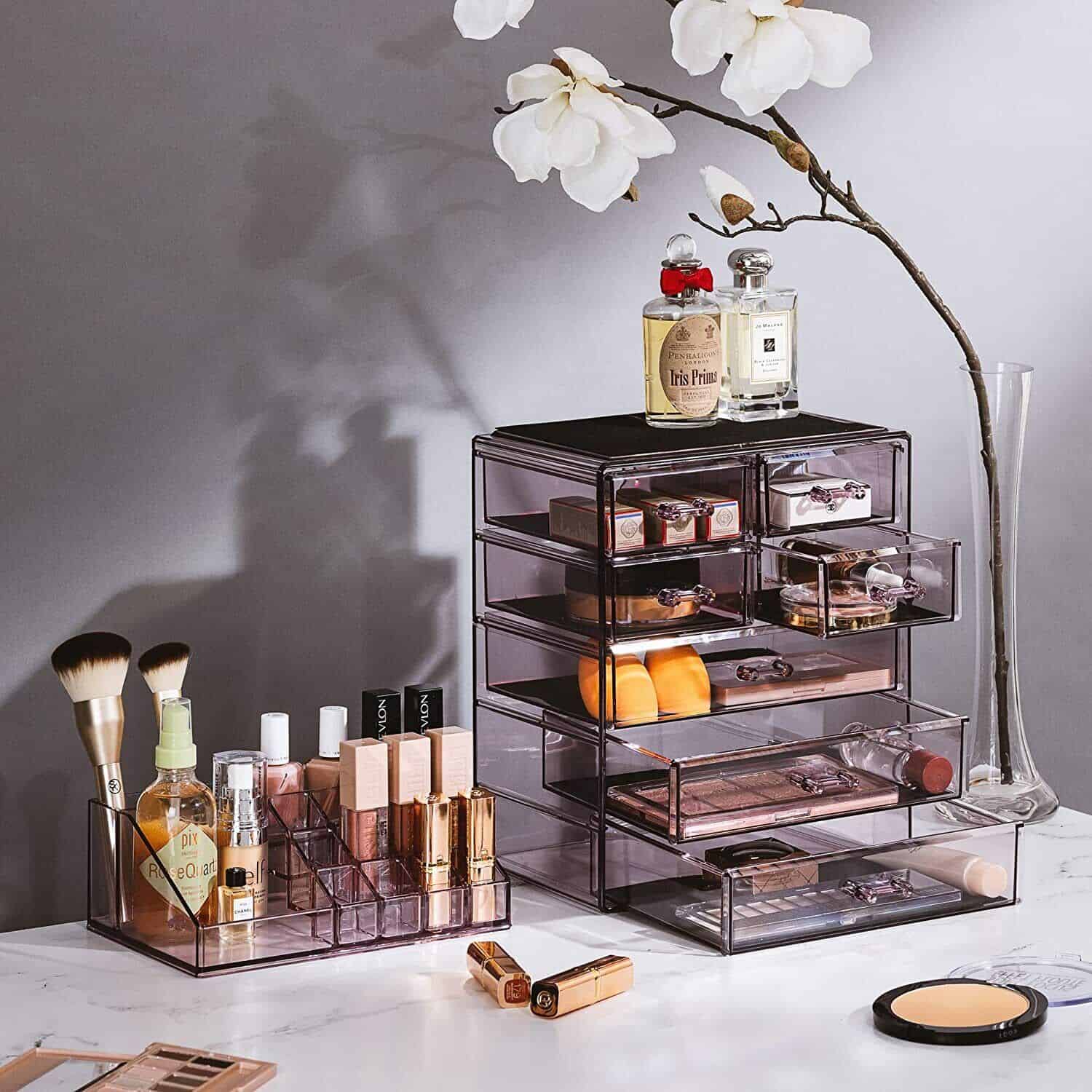 A makeup organizer with several drawers and a flower.