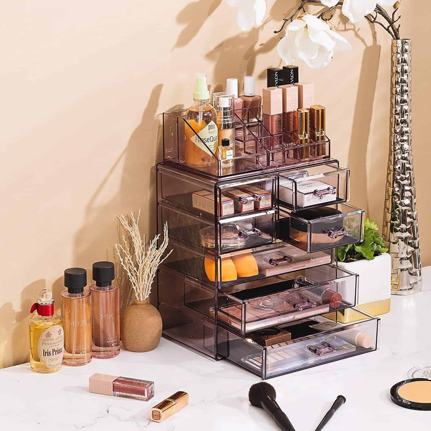 A makeup organizer with cosmetics and brushes on a counter.