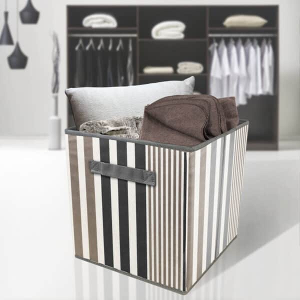 A black and white striped storage bin in a closet.