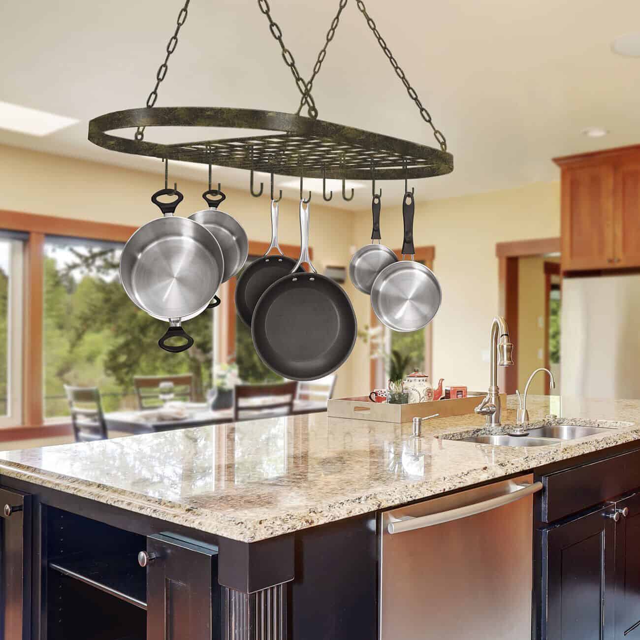 A kitchen with pots hanging from the ceiling.