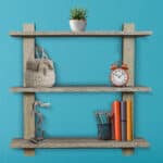 A wooden shelf on a blue wall.