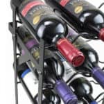 A wine rack with six bottles in it.