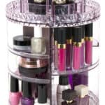 A round makeup organizer with lipsticks and other cosmetics.