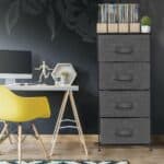 A gray storage cabinet with a yellow chair and a yellow wall.