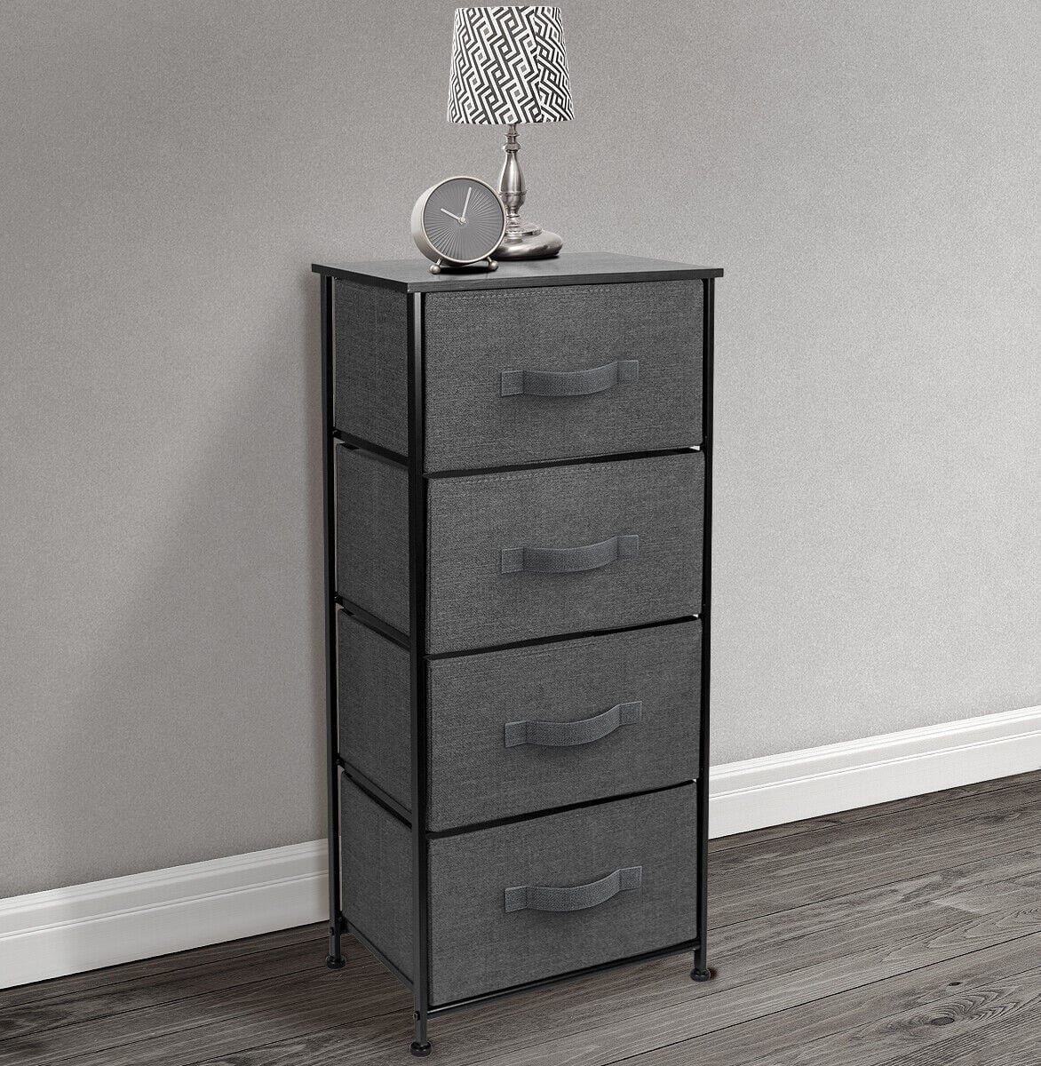 A grey dresser with four drawers and a lamp.