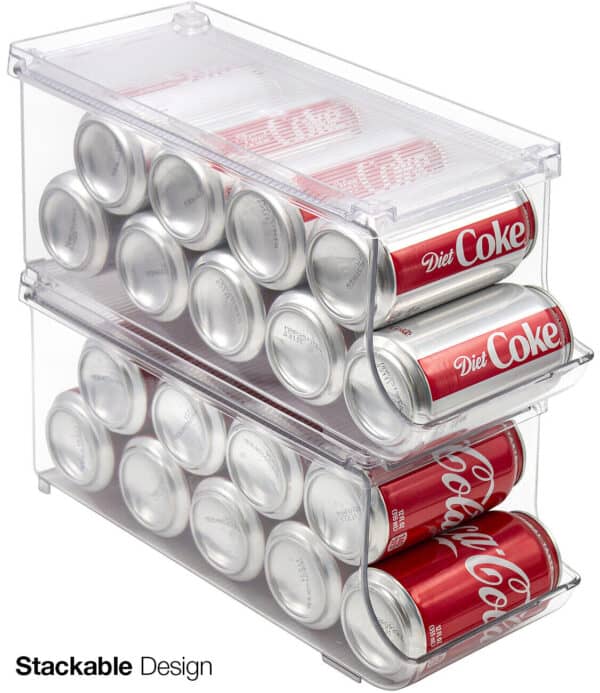 Two cans of coca cola in a clear storage container.