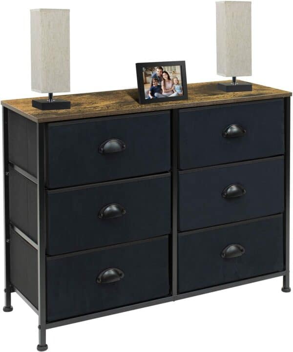 A black dresser with drawers and a picture on it.