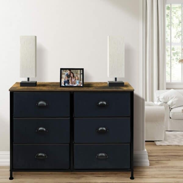 A black dresser with drawers in a living room.