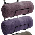 Four towels are stacked on a black towel rack.