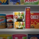 A shelf with a variety of food items on it.