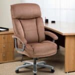 A brown office chair in front of a desk.