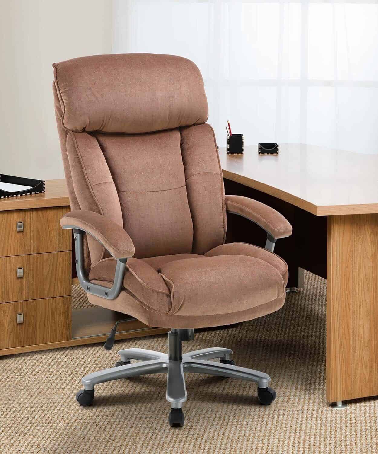 A brown office chair in front of a desk.
