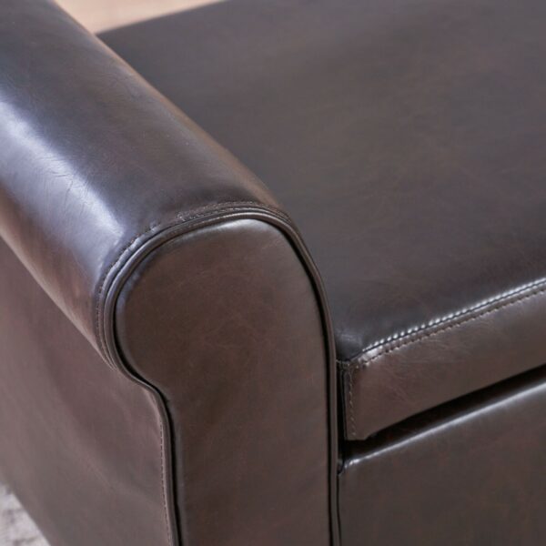 A close up of a brown leather ottoman.