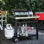 A barbecue grill on a wooden deck.