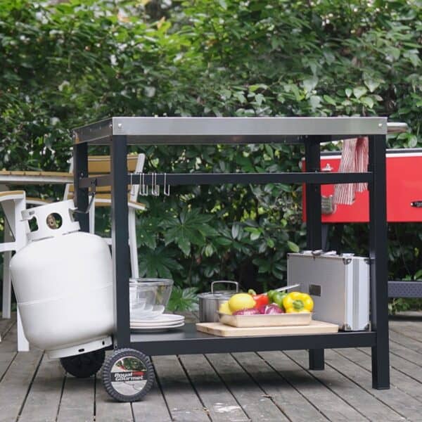 A barbecue cart with a propane tank and food on it.