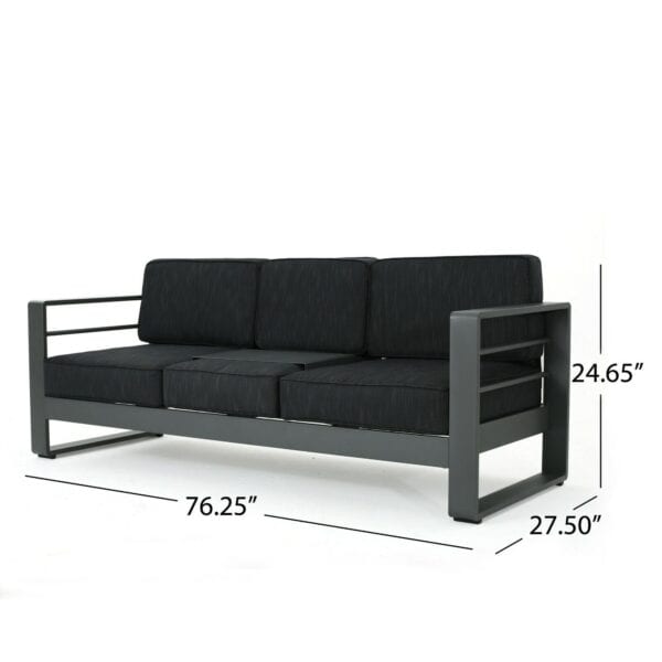 A black sofa with black cushions and measurements.