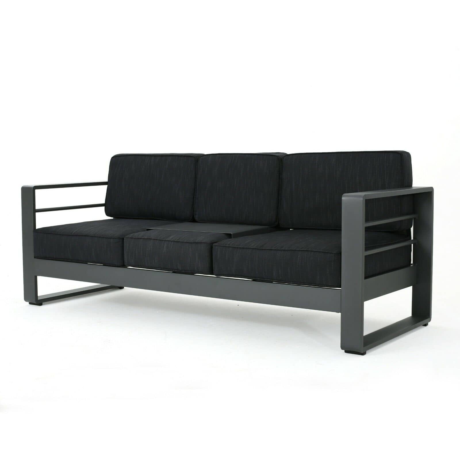 A black sofa with black cushions on a white background.