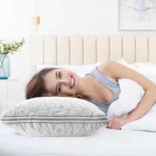 A woman laying on a bed with a pillow.