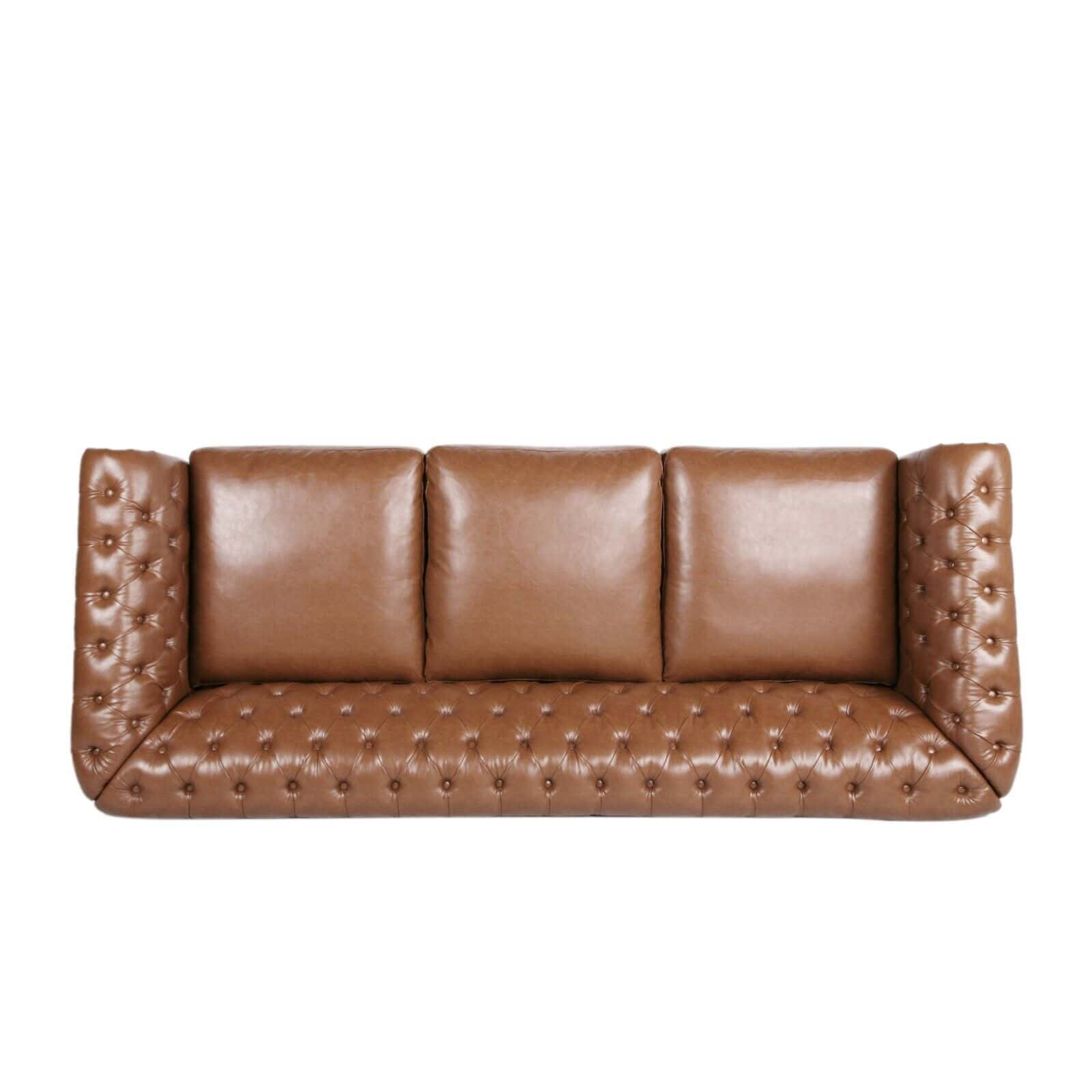 A tan leather sofa with buttons on the back.