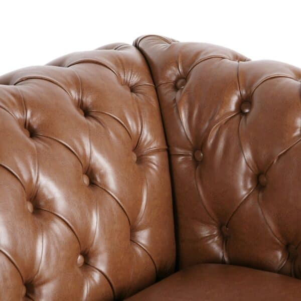 A close up of a brown leather chesterfield chair.