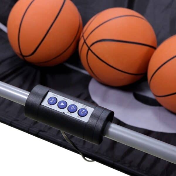 A basketball hoop with three balls and a remote control.
