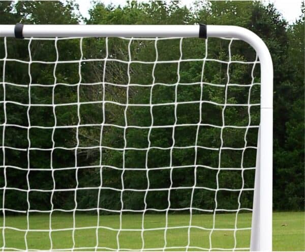 A soccer goal with a net in the middle of a field.