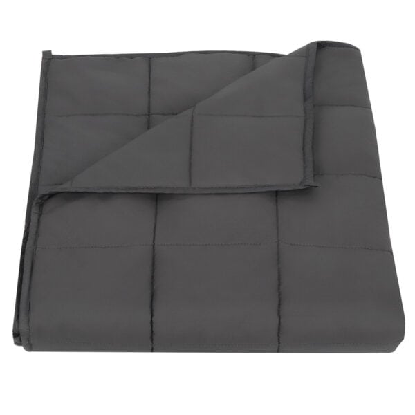 A grey quilted blanket folded up on a white background.