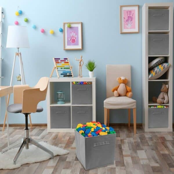 A child's room with lots of toys and a chair.