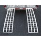 A pair of aluminum ramps on the back of a truck.