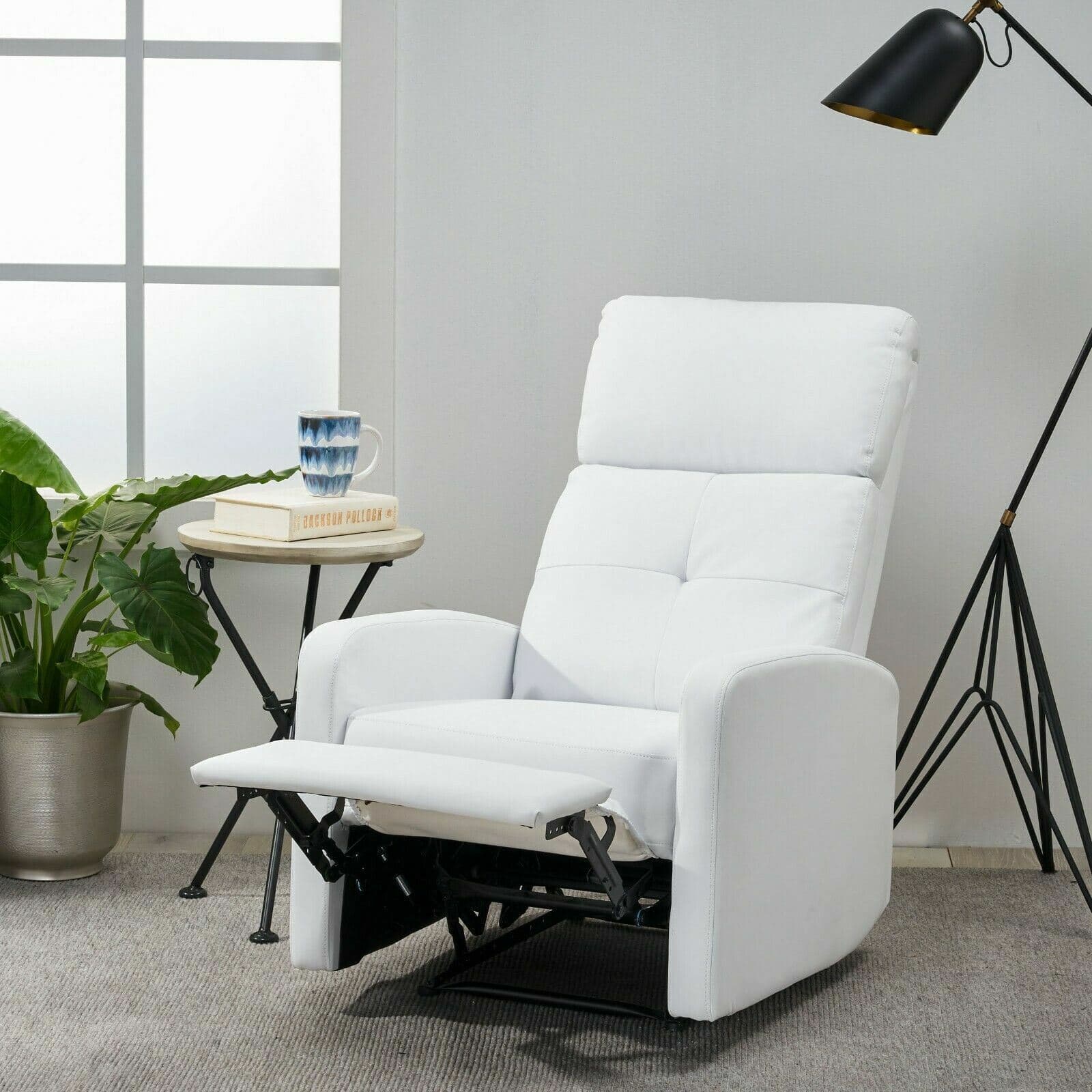 A white recliner chair in a living room.