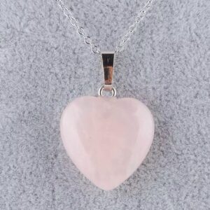 A rose quartz heart pendant on a silver chain.