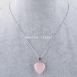 A rose quartz heart pendant on a silver chain.