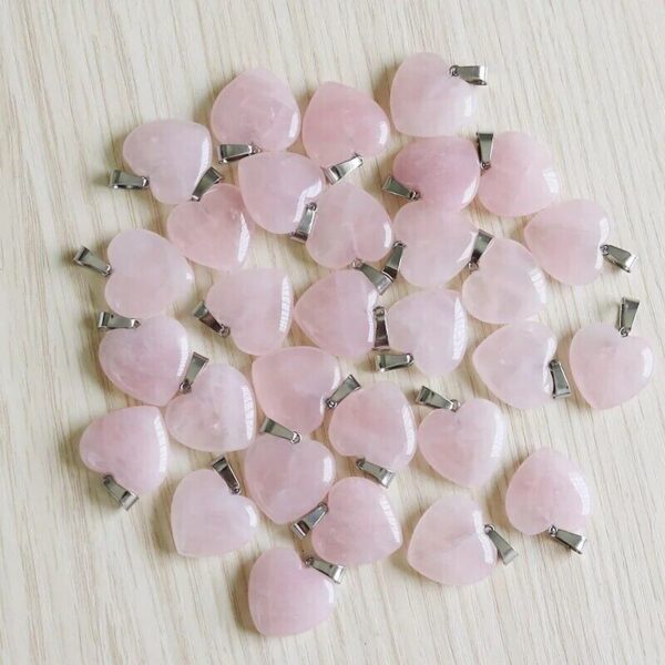 A pile of pink heart shaped stones on a table.