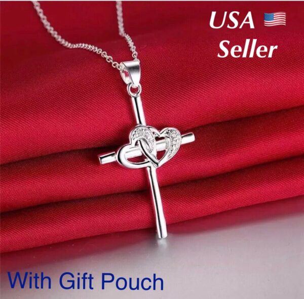 A silver cross necklace with a gift pouch.