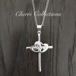 A silver cross necklace with a heart on it.