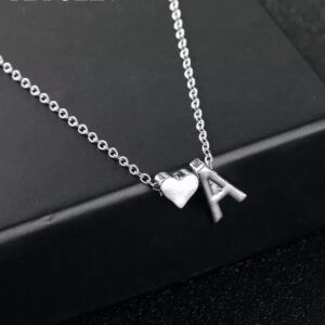 A silver necklace with an initial and a heart.